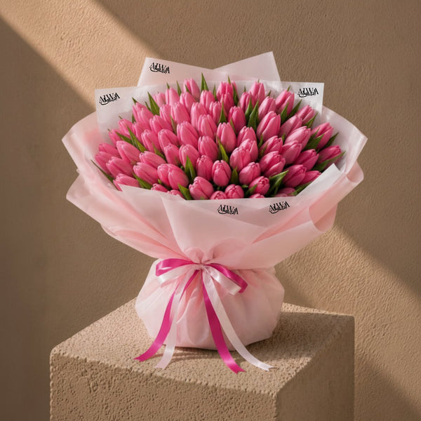 Grand pink tulip hand-tied bouquet in blush wrap with pink ribbon - Tulip Tapestry by AIWA Flowers