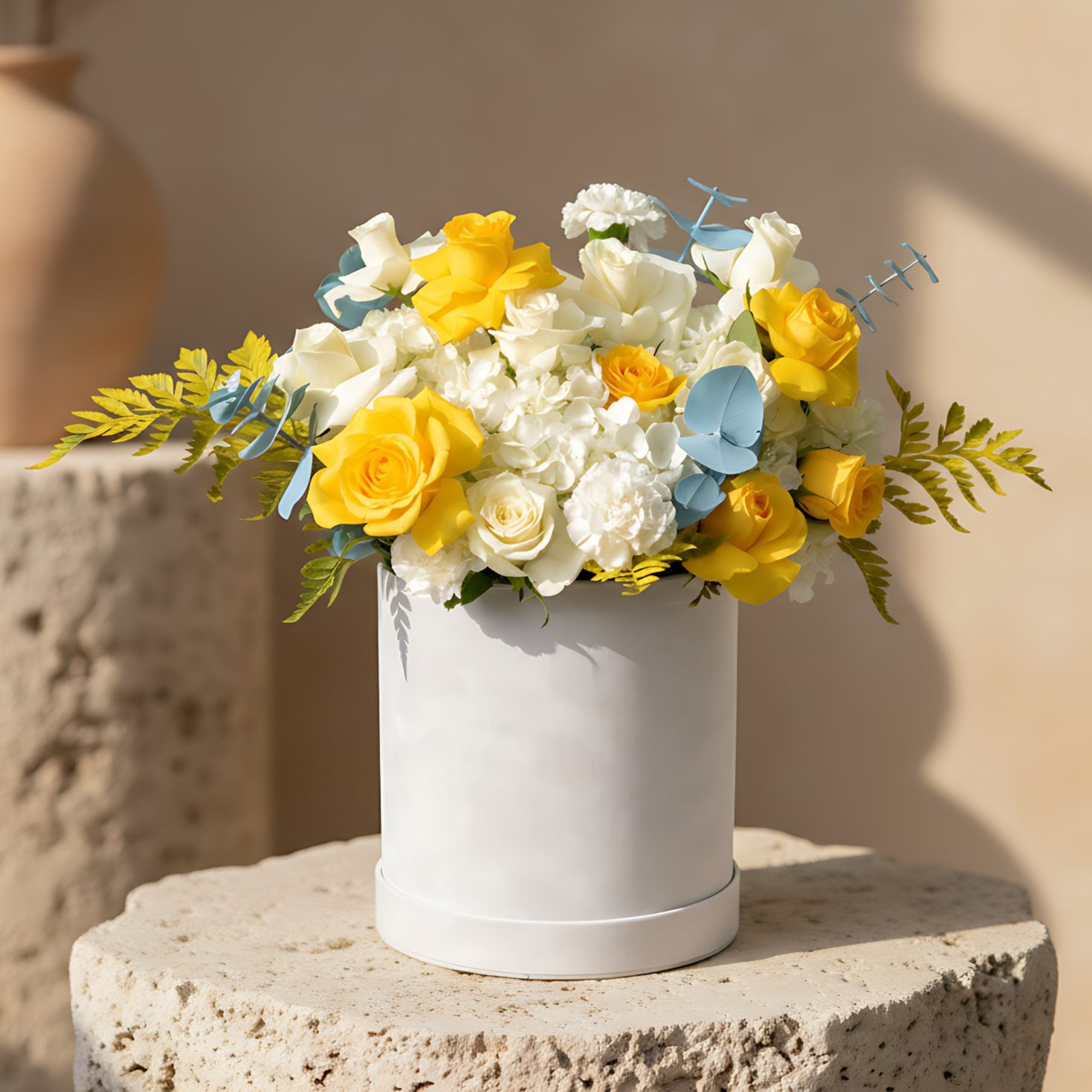 Unco white velvet flower box with yellow and white roses, white hydrangeas and blue eucalyptus