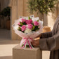 Woman holding a pink rose bouquet with hydrangea, lilies and a pink heart accent - Unwavering Love by AIWA Flowers