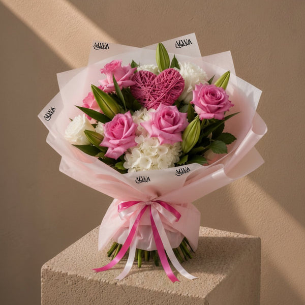 Pink roses, white hydrangea and lilies with a pink yarn heart in blush wrap - Unwavering Love by AIWA Flowers