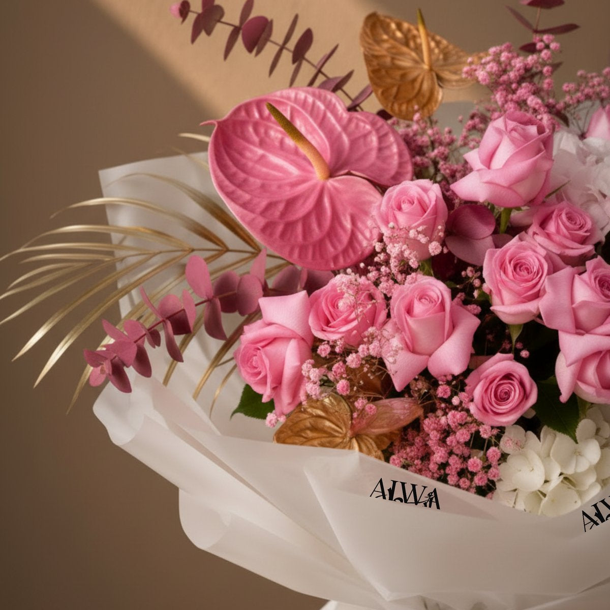 Close-up of pink roses, pink anthurium, gypsophila and gold accents – Versailles Garden by AIWA Flowers