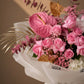 Close-up of pink roses, pink anthurium, gypsophila and gold accents – Versailles Garden by AIWA Flowers