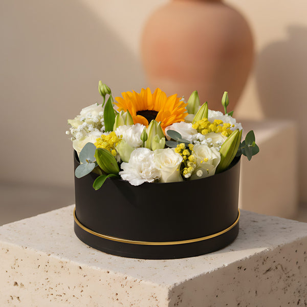 Wealth black flower box with white roses, sunflower, lilies, lisianthus and gypsophila