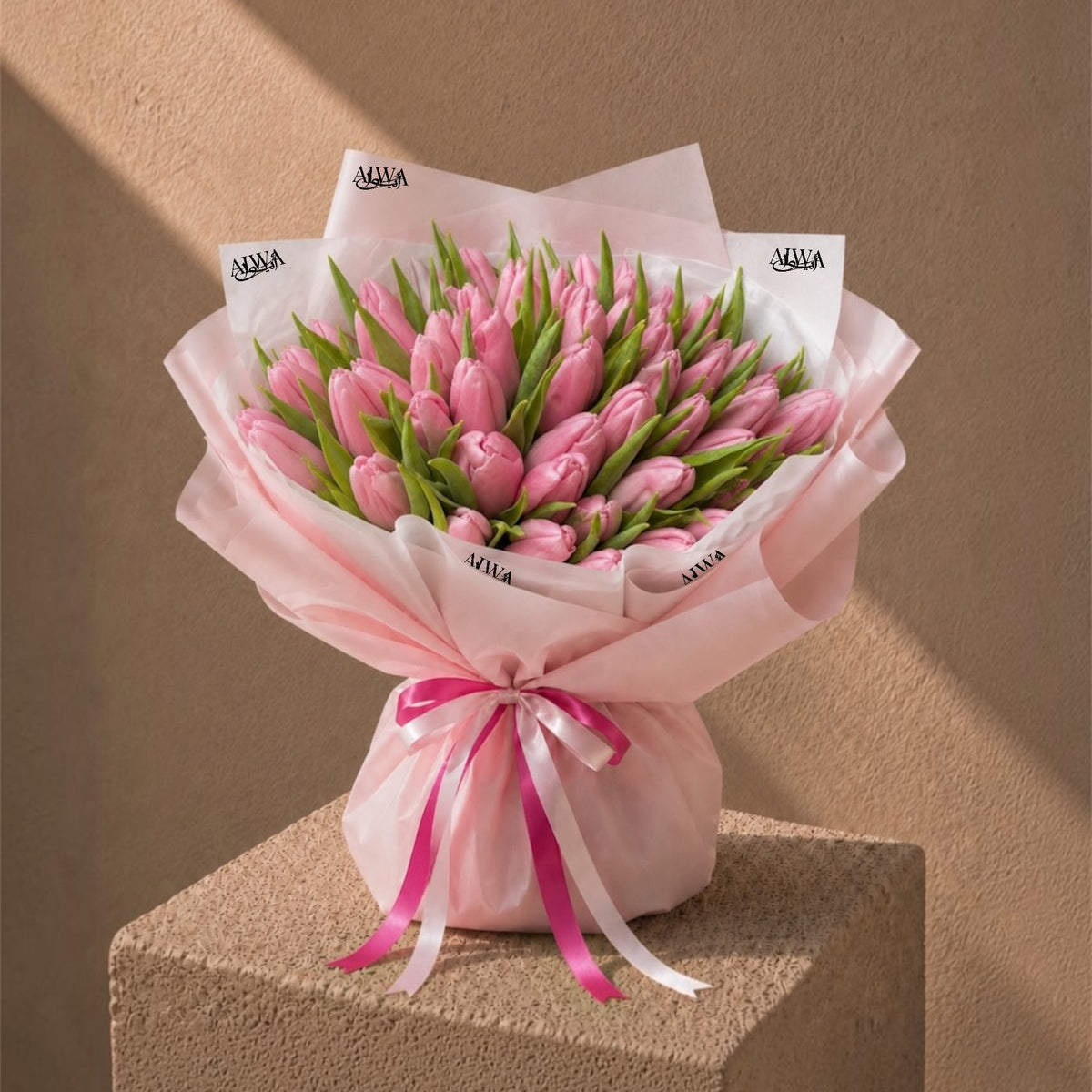 Full studio shot of a large pink tulip bouquet in blush wrap - Whispering Tulips by AIWA Flowers Dubai