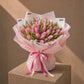 Full studio shot of a large pink tulip bouquet in blush wrap - Whispering Tulips by AIWA Flowers Dubai