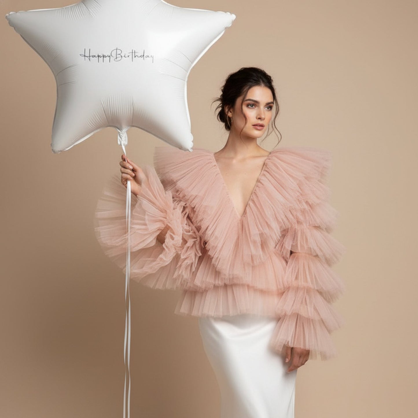model holding white star birthday balloon