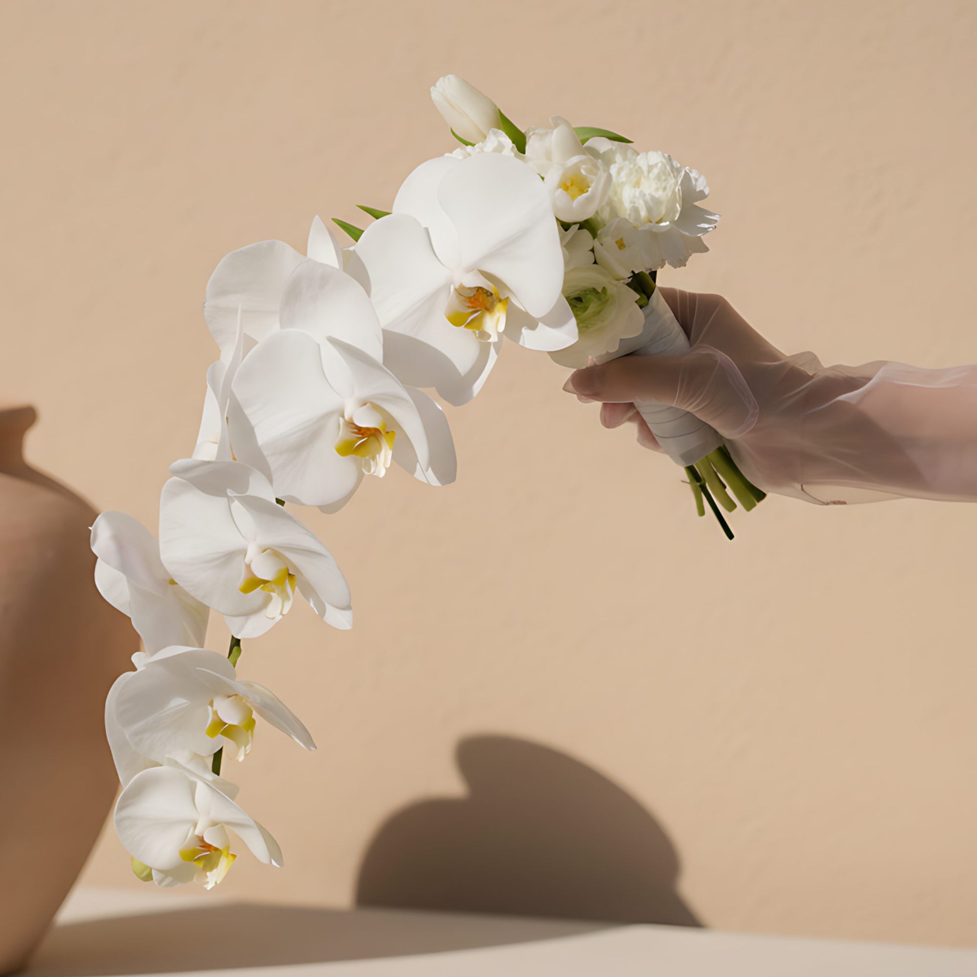 Winds bridal bouquet with white orchid stem, white tulips and white carnation by Aiwa Flowers